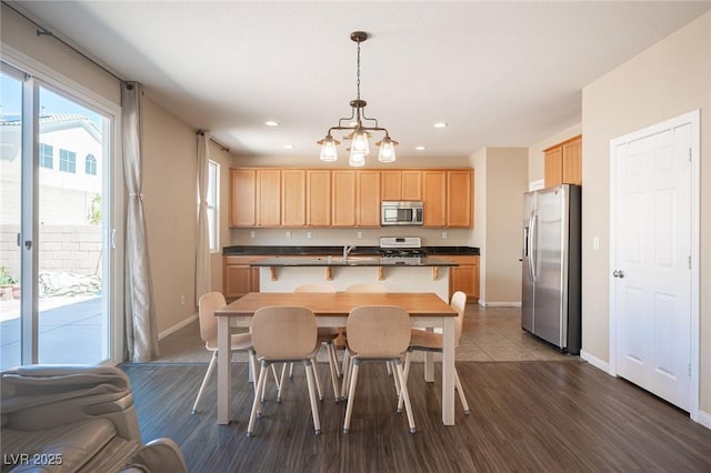 dining room with recessed lighting, dark wood-style flooring, baseboards, and a notable chandelier