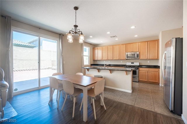 dining space with recessed lighting, wood finished floors, visible vents, baseboards, and a chandelier