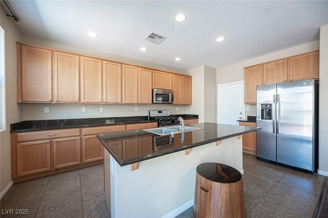 kitchen featuring light brown cabinets, appliances with stainless steel finishes, visible vents, and dark tile patterned flooring
