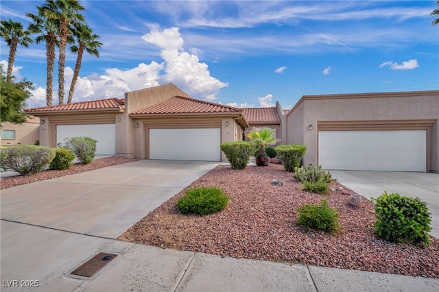 1074 Chaparral Dr, Mesquite, NV 89027 - view of front of home with stucco siding, concrete driveway, a tiled roof, and a garage