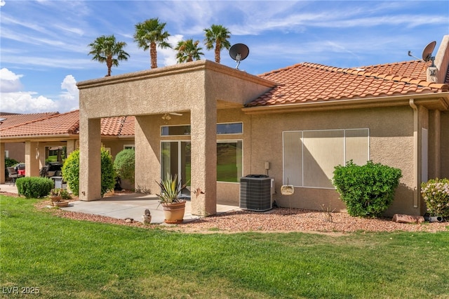 1074 Chaparral Dr, Mesquite, NV 89027 - back of house featuring stucco siding, a tile roof, a lawn, and a patio