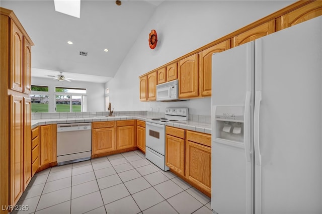 1074 Chaparral Dr, Mesquite, NV 89027 - kitchen featuring white appliances, light tile patterned flooring, high vaulted ceiling, tile countertops, and recessed lighting
