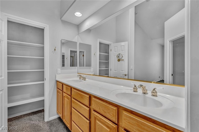 1074 Chaparral Dr, Mesquite, NV 89027 - bathroom with double vanity, vaulted ceiling, and a walk in closet