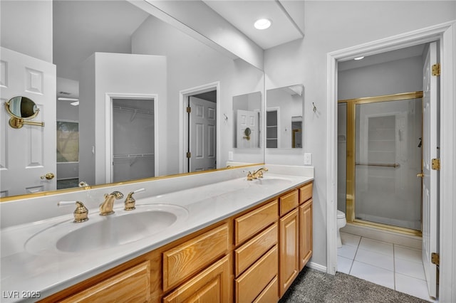 1074 Chaparral Dr, Mesquite, NV 89027 - bathroom with a stall shower, double vanity, tile patterned floors, and a spacious closet