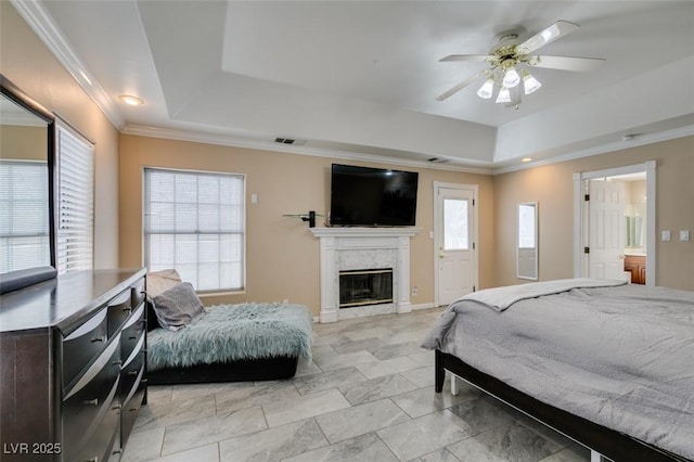 6520 Turtle Hill Rd, Las Vegas, NV 89110 - bedroom with a tray ceiling, visible vents, a ceiling fan, crown molding, and a glass covered fireplace