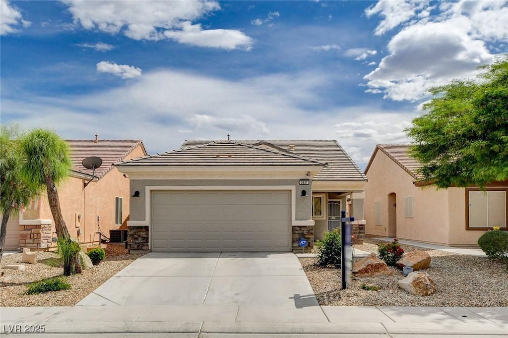 ranch-style house with a garage, stucco siding, concrete driveway, and stone siding