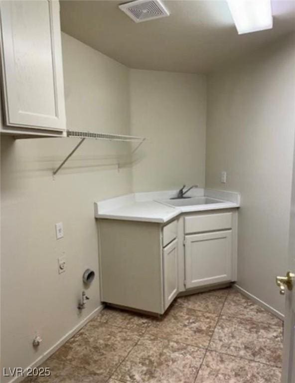 1003 Dover Glen Dr, North Las Vegas, NV 89031 - laundry room featuring a sink, cabinet space, visible vents, baseboards, and hookup for a gas dryer
