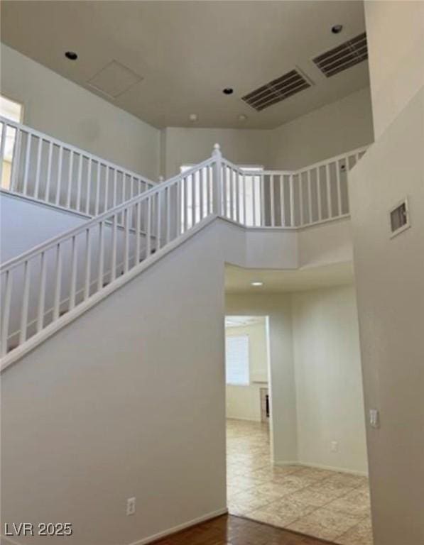 1003 Dover Glen Dr, North Las Vegas, NV 89031 - stairs with baseboards, visible vents, and a high ceiling