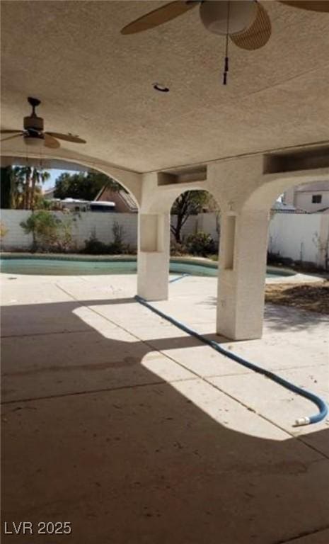 1003 Dover Glen Dr, North Las Vegas, NV 89031 - view of patio featuring fence, ceiling fan, and an outdoor pool