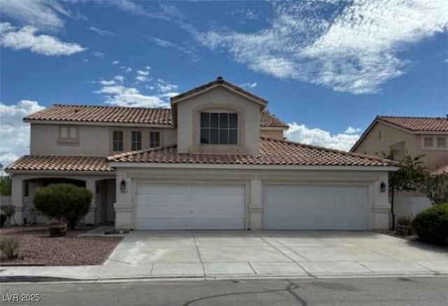 1003 Dover Glen Dr, North Las Vegas, NV 89031 - mediterranean / spanish-style house featuring a garage, a tile roof, driveway, and stucco siding