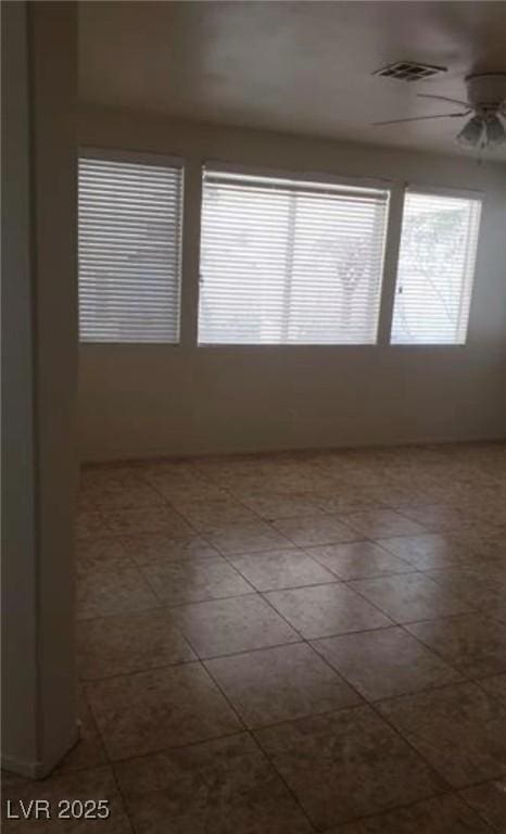 1003 Dover Glen Dr, North Las Vegas, NV 89031 - empty room featuring ceiling fan, tile patterned floors, and visible vents