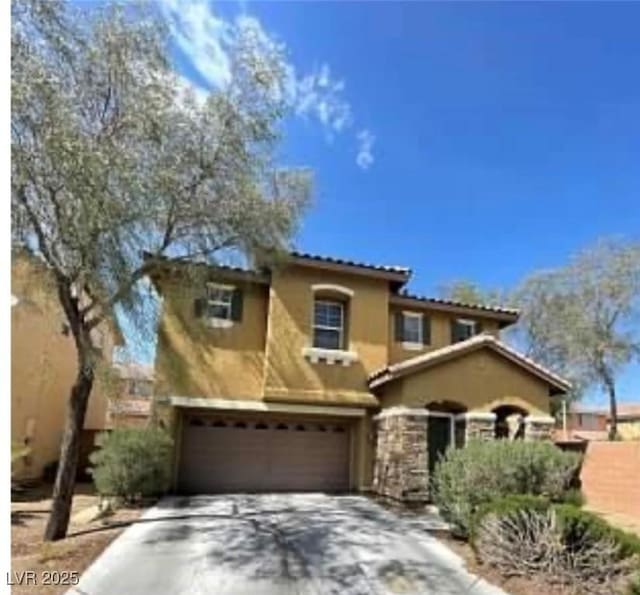 8768 Charm Canyon Ave, Las Vegas, NV 89178 - mediterranean / spanish home with stucco siding, concrete driveway, and a garage