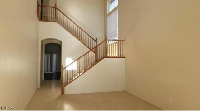 8768 Charm Canyon Ave, Las Vegas, NV 89178 - stairway with arched walkways and a high ceiling