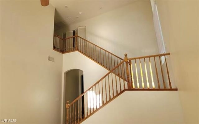 8768 Charm Canyon Ave, Las Vegas, NV 89178 - stairway featuring arched walkways, visible vents, and high vaulted ceiling