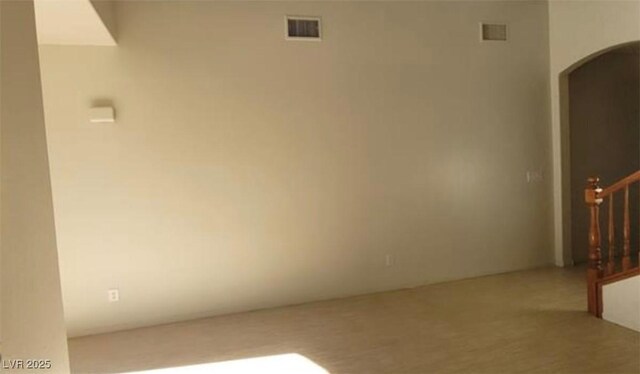 8768 Charm Canyon Ave, Las Vegas, NV 89178 - unfurnished room with visible vents, arched walkways, and stairway