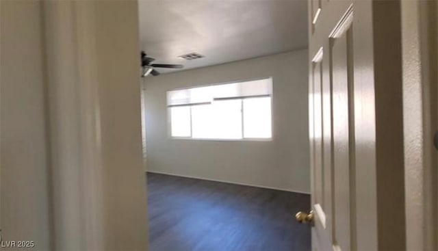 8768 Charm Canyon Ave, Las Vegas, NV 89178 - unfurnished room with visible vents, dark wood-style floors, and ceiling fan