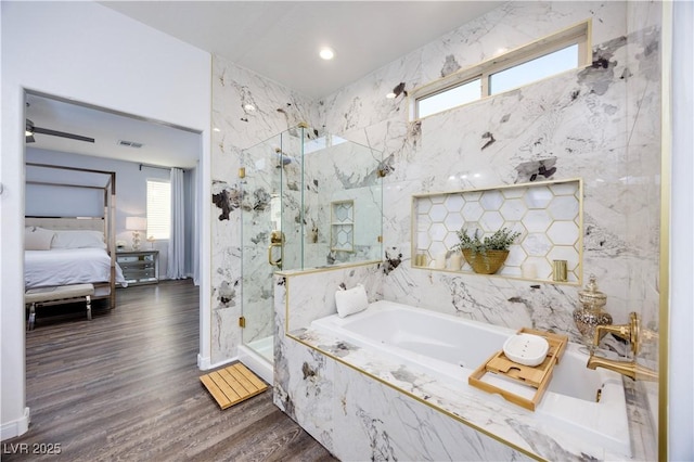 ensuite bathroom with a garden tub, wood finished floors, ensuite bathroom, a marble finish shower, and visible vents