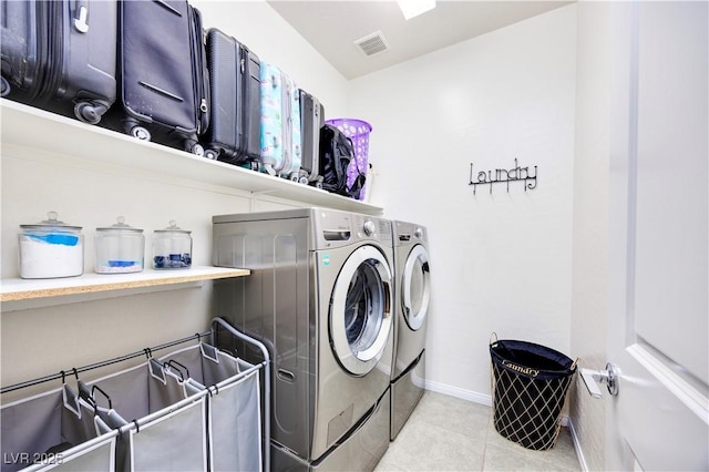 washroom featuring visible vents, washing machine and dryer, baseboards, tile patterned flooring, and laundry area