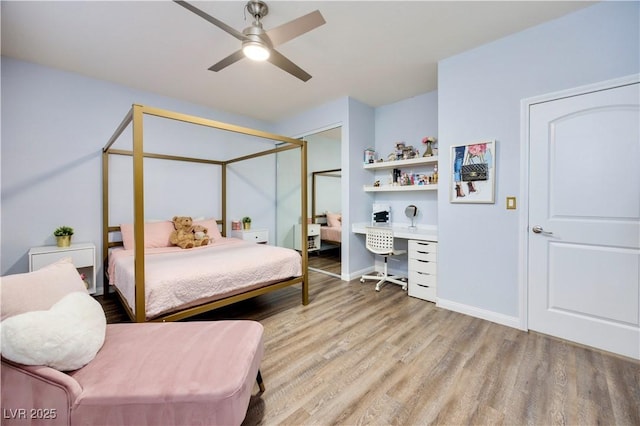 bedroom with light wood finished floors, a ceiling fan, and baseboards