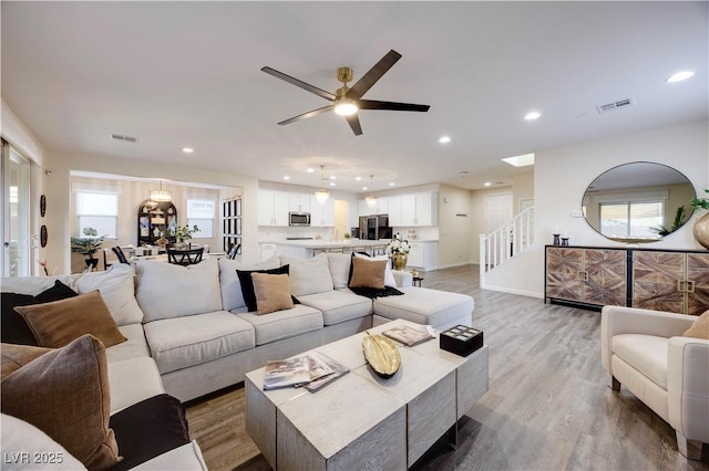 living area with light wood finished floors, recessed lighting, and a healthy amount of sunlight