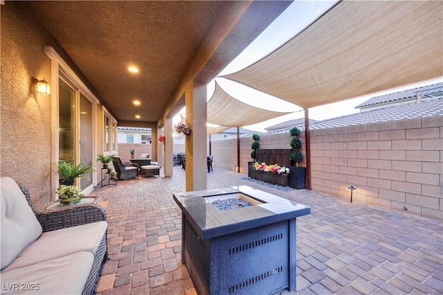 view of patio / terrace featuring a fenced backyard and an outdoor living space with a fire pit