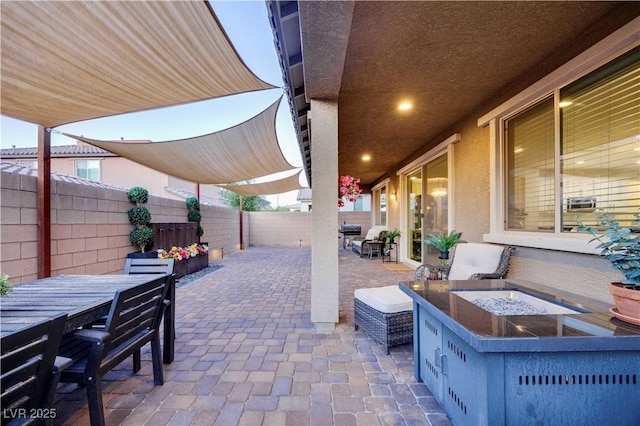 view of patio featuring a fenced backyard and outdoor dining area