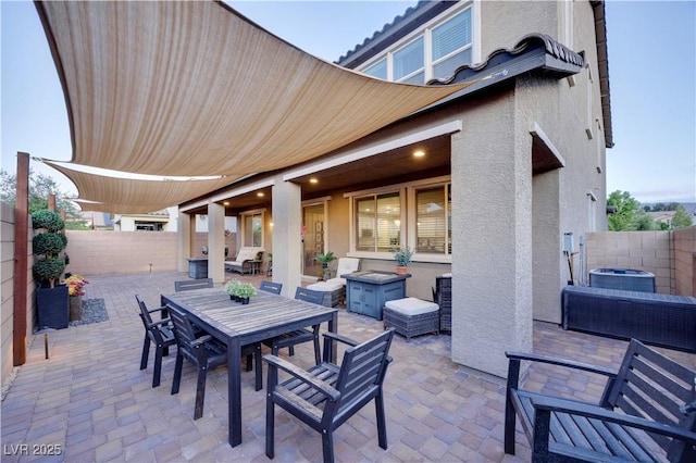 view of patio with outdoor dining area and a fenced backyard