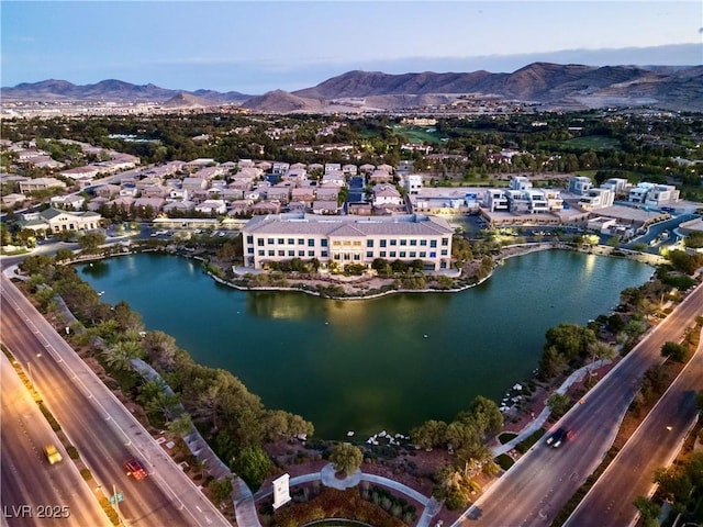 birds eye view of property featuring a water and mountain view