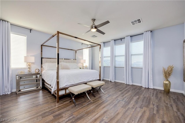 bedroom with baseboards, wood finished floors, and visible vents