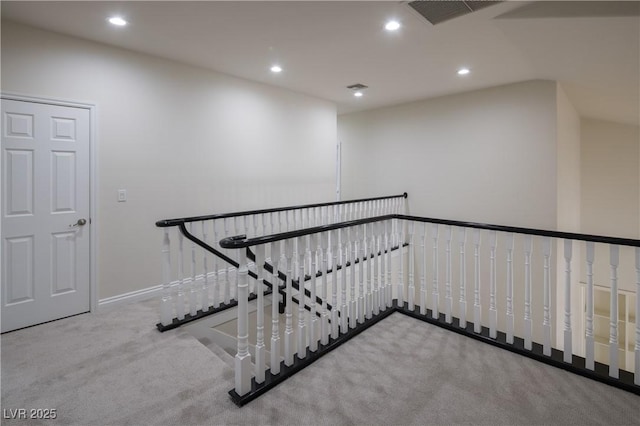 stairway featuring baseboards, recessed lighting, visible vents, and carpet