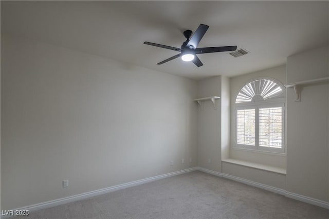 empty room with ceiling fan, visible vents, baseboards, and light carpet