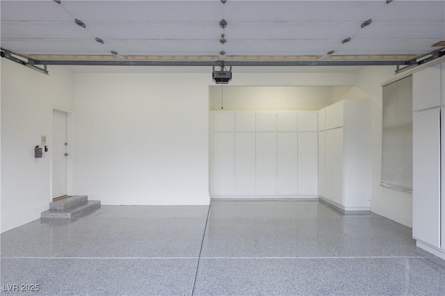 garage featuring baseboards and a garage door opener