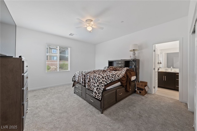31 Strada Loreto, Henderson, NV 89011 - bedroom with baseboards, ensuite bath, light colored carpet, and ceiling fan