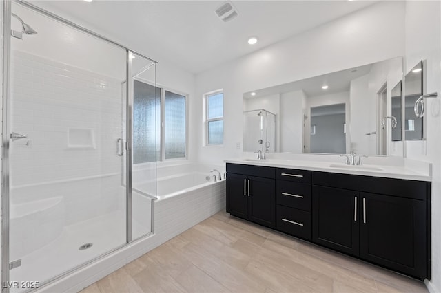 31 Strada Loreto, Henderson, NV 89011 - full bathroom featuring a sink, double vanity, visible vents, a shower stall, and a garden tub