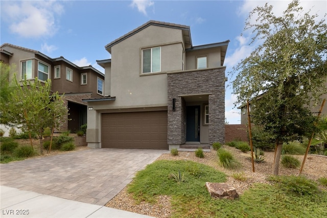 31 Strada Loreto, Henderson, NV 89011 - view of front facade with stucco siding, driveway, stone siding, and a garage