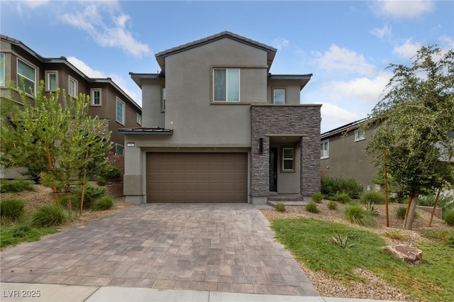 31 Strada Loreto, Henderson, NV 89011 - view of front of home featuring stucco siding, stone siding, decorative driveway, and a garage