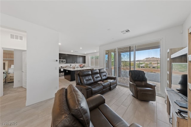 31 Strada Loreto, Henderson, NV 89011 - living room featuring light wood-style flooring, visible vents, and recessed lighting
