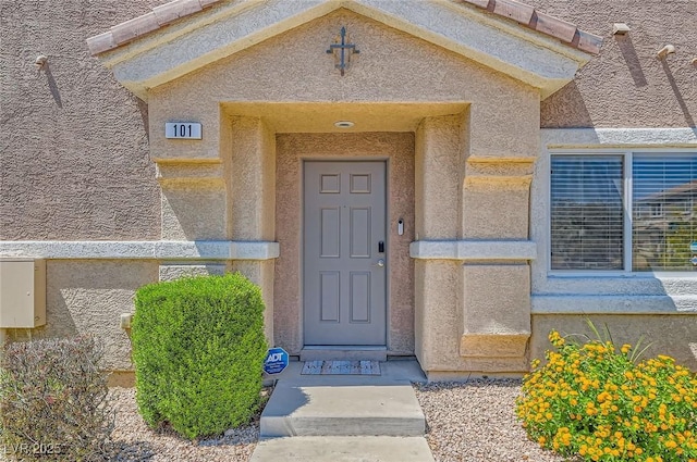 entrance to property with stucco siding