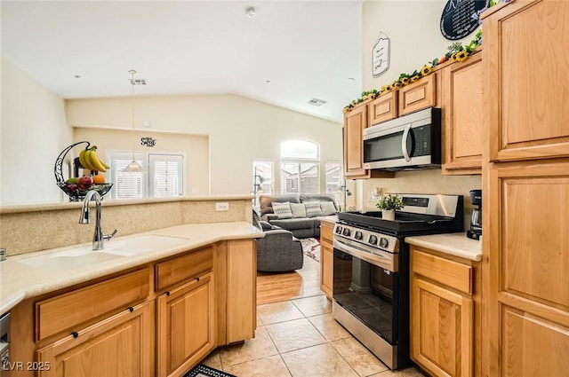 kitchen with light tile patterned floors, a sink, visible vents, appliances with stainless steel finishes, and lofted ceiling