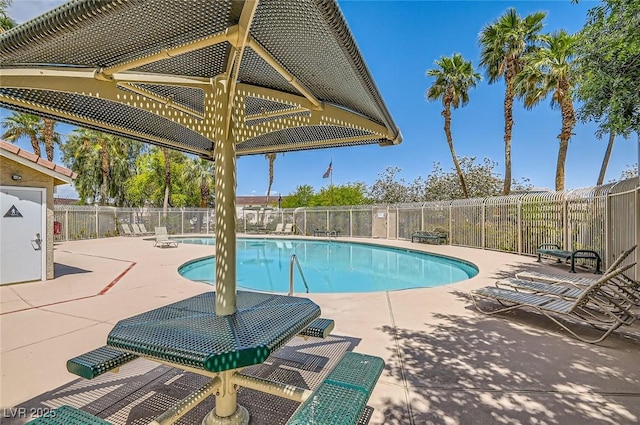 community pool featuring a patio and fence