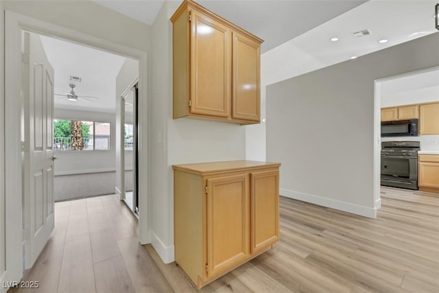 hallway with baseboards, visible vents, and light wood-style flooring
