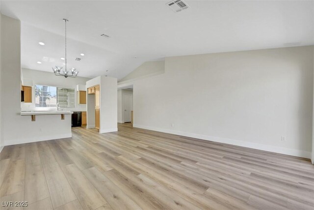 unfurnished living room featuring an inviting chandelier, light wood-style flooring, baseboards, visible vents, and recessed lighting