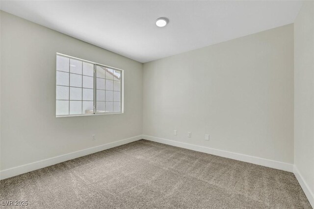 carpeted empty room with baseboards