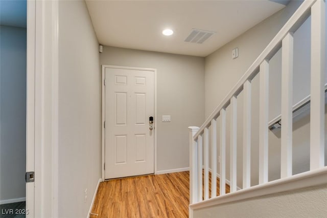 entryway featuring stairs, wood finished floors, recessed lighting, and baseboards