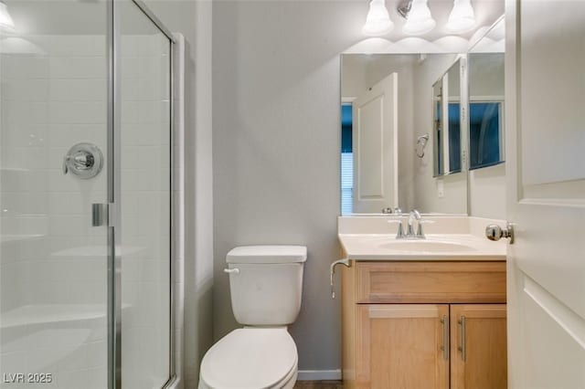full bathroom with toilet, a shower stall, and vanity