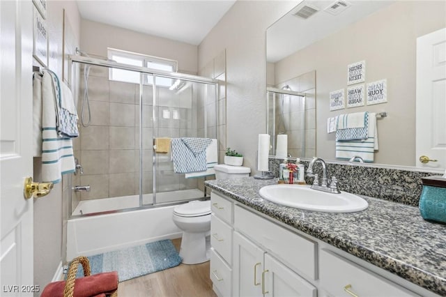 5286 Monterey Park Cir, Las Vegas, NV 89146 - full bathroom with wood finished floors, vanity, combined bath / shower with glass door, and toilet