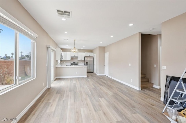 5286 Monterey Park Cir, Las Vegas, NV 89146 - unfurnished living room featuring light wood-style flooring, baseboards, stairway, and recessed lighting