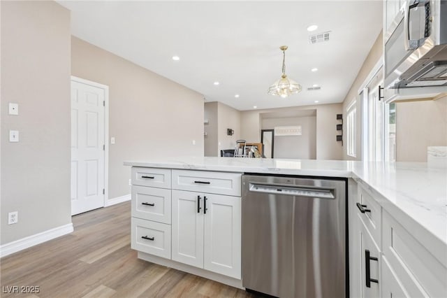 5286 Monterey Park Cir, Las Vegas, NV 89146 - kitchen with appliances with stainless steel finishes, a chandelier, white cabinetry, light wood-type flooring, and light stone counters