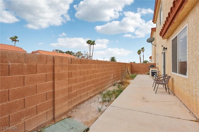 5286 Monterey Park Cir, Las Vegas, NV 89146 - view of patio featuring a fenced backyard and a grill