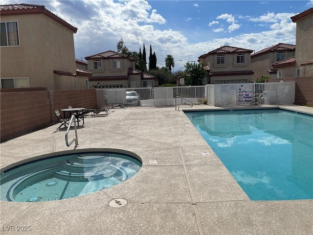 5286 Monterey Park Cir, Las Vegas, NV 89146 - community pool with fence, a patio area, and a hot tub